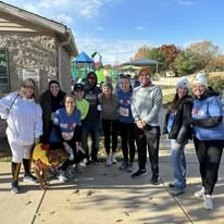 A group of volunteers and supporters posing together