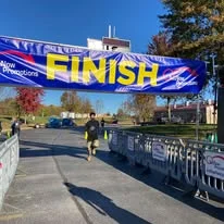 A runner approaching the finish line banner